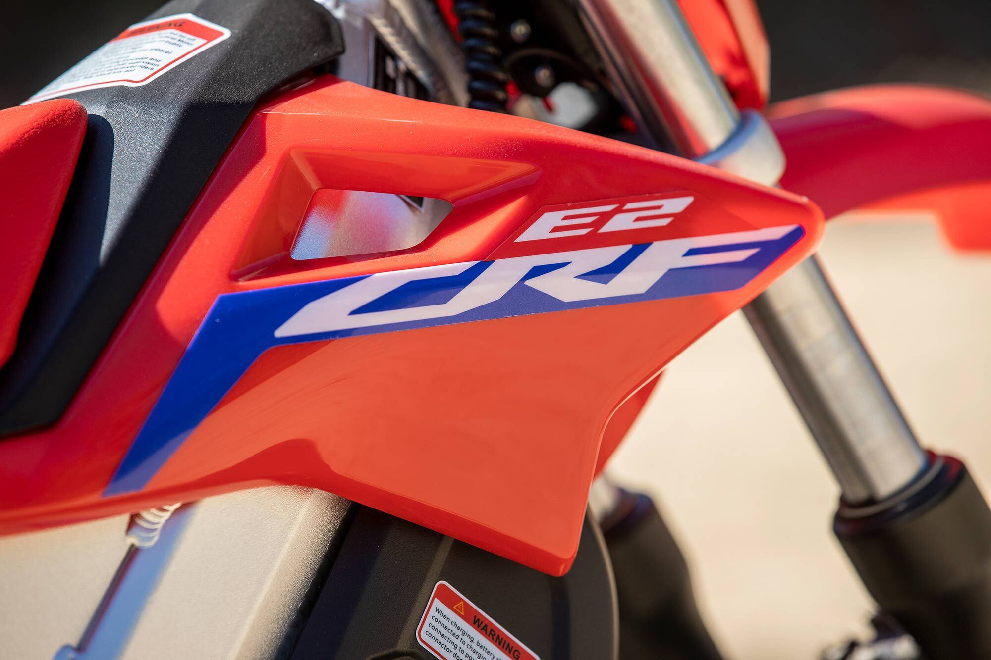 The electric CRF-E2 doesn’t exactly “need” radiator shrouds, and yet how can it look moto without them?!